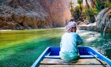 Wadi Shab Man with Boat 935x543