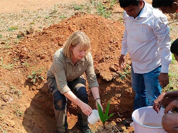 Sustainable Tourism India - Tourist planting a coconut palm in South India