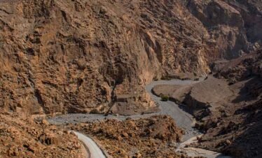 canyon and view of the winding road to Jebel Al Harim (Jabal Al Harim
